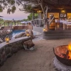 View of the main dining area, with fire pit to relax around, and pool area.