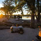 Waterhole at sunset at Hyena Pan Tented Camp in Botswana