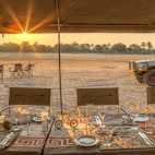 Dining table and safari vehicle in Botswana