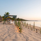 Dining on the beach at Anantara Bazaruto Island Resort in Mozambique.