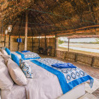 Bedroom and river view at Takwela Camp in North Luangwa National Park, Zambia.