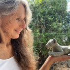 Client with lion sculpture on our Wildlife Art Safari in South Luangwa, Zambia