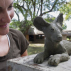 Client with wild dog sculpture in South Luangwa, Zambia
