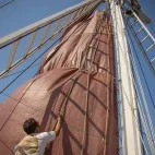 A crew member putting up the sails on Katharina, in Indonesia.