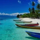 Boats moored on a beach in Raja Ampat, Indonesia