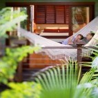 Guests relaxing in a hammock at Silky Oaks Lodge, Queensland, Australia.