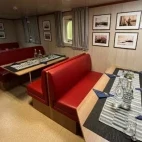 The dining room with tables laid up, on board Virgo.