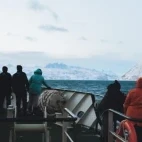 External view of passengers enjoying the view from deck.