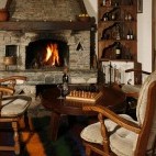 Fireplace and seating area at Arkan Han in Trigrad, Bulgaria