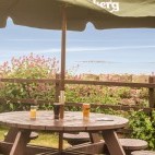 Outdoor seating area at Bamburgh Castle Inn, looking out to the Farne Islands in Northumberland