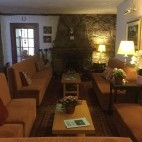 Fireplace and seating in the reception area at The Old Inn in Gairloch, Scotland