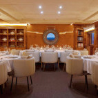 Indoor dining room on board Aqua Mare liveaboard in the Galapagos Islands.