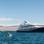 Kayakers and Origin vessel in the Galapagos.