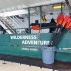 Internal view of part of the deck of Wilderness Adventurer, with vessel name and paddles ready for avid kayakers.