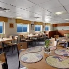 The communal dining area on board Wilderness Adventurer.