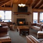 Lounge with fireplace at Farewell Harbour Lodge in British Columbia