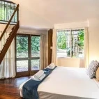 A family suite with double bed, at Ferntree Rainforest Lodge, Queensland