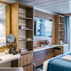 View of a category C room on Ocean Victory, Antarctica, with large mirror and vanity.