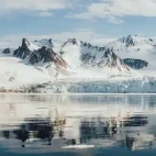 View of a glacier and looming mountains in Svalbard.