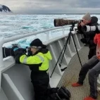 Photographers poised for wildlife sightings on the deck of Explorer, Arctic.