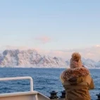 Guest enjoying the Arctic landscape from the deck of Explorer.