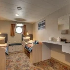 Twin room with porthole window on board Plancius.