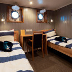 Single porthole cabin on board MS Sjøveien in Svalbard.