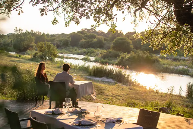 Couple eating on a terrace at Dulini River Lodge in South Africa