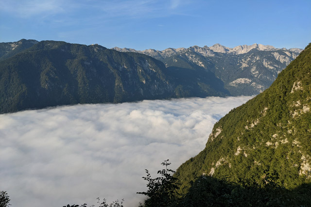 Clouds beneath the mountains in Lake Bohinj, Slovenia